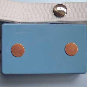 Blue electronic device with two copper-colored circular electrodes and white strap with metal snap fastener