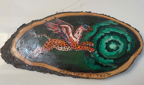 Painted wooden slice showing decorative art with bird, green spiral pattern, and text "PERCEPTION OF TRUTH" along bottom edge