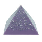 Purple orgonite pyramid with clear resin top section containing small metallic fragments, viewed from front angle