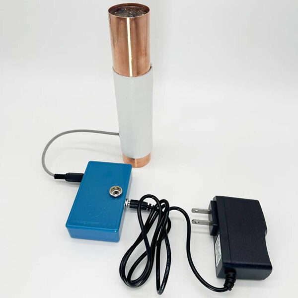 Copper and white cylindrical device with blue control box, black power adapter, and connecting cables on white background