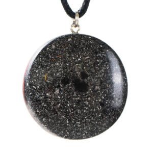Black circular pendant with sparkly metallic flecks and central dark cavity, hanging from black cord with silver bail