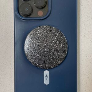 Blue silicone phone case with triple camera cutout, circular black glittery disc attached, white lightning bolt symbol below