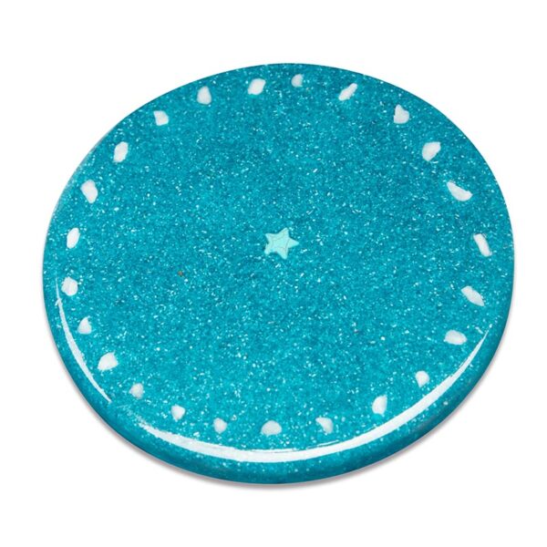 Round turquoise charging plate with glittery surface, white dots around perimeter, and small star shape in center
