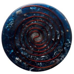 Round blue orgonite disc with red spiral pattern and embedded metal shavings, viewed from above