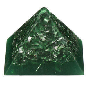 Green translucent orgonite pyramid with metallic spiral coils and shavings embedded inside, photographed against white background