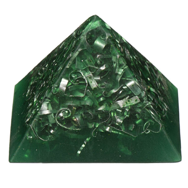 Green translucent orgonite pyramid with metallic spiral coils and shavings embedded inside, photographed against white background