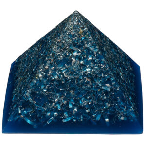 Blue transparent orgonite pyramid with metallic shavings and particles embedded throughout, photographed against white background
