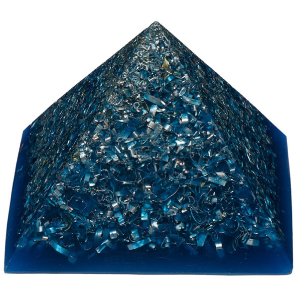 Blue transparent orgonite pyramid with metallic shavings and particles embedded throughout, photographed against white background