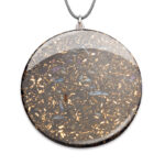Large circular orgonite pendant with grey cord, containing metallic flakes and crystals in translucent resin with silver setting