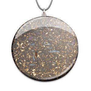 Large circular orgonite pendant with grey cord, containing metallic flakes and crystals in translucent resin with silver setting